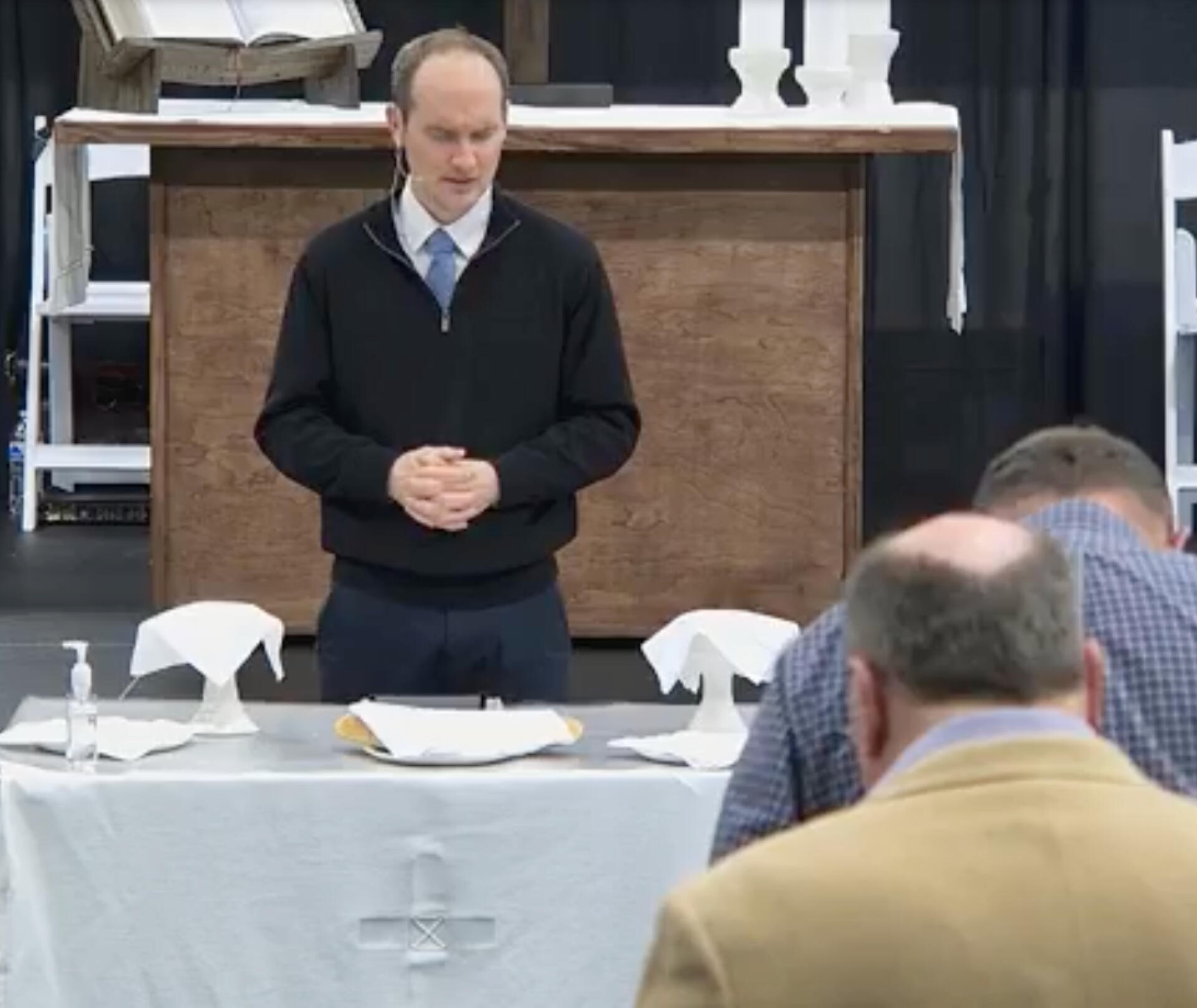 Kyle leads communion at a church